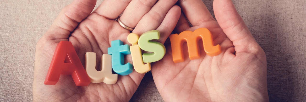 4 Things About Autism That Are Often Misunderstood Autism colorful word on hands.