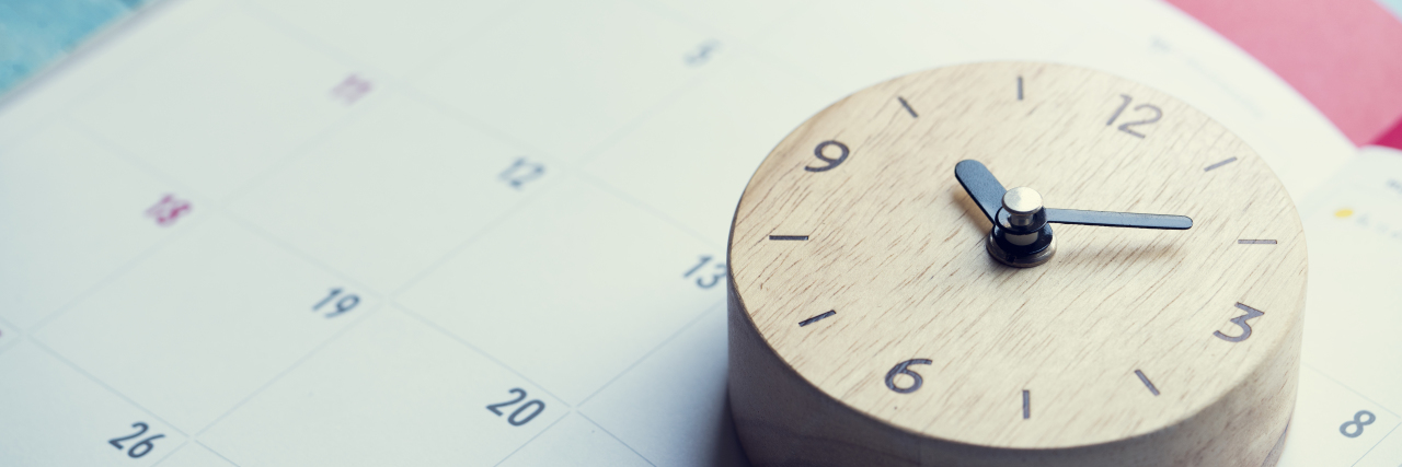 Maintaining Routine on the Autism Spectrum Calendar and clock on table.