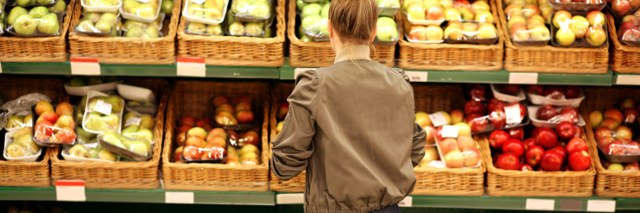 A woman is buying produce at the grocery store.