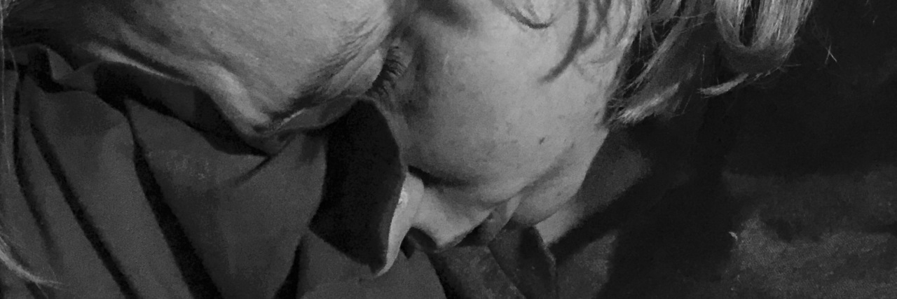The Reality Behind Viral Social Media Photos About Mental Health black and white photo of the contributor looking upset with head resting on her shoulder and eyes closed