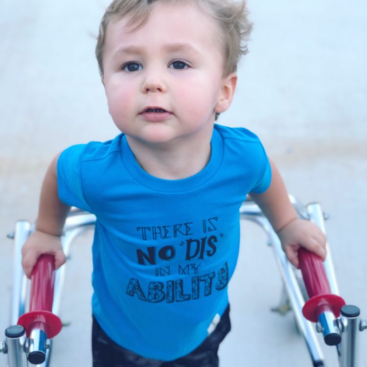 Little boy using walker