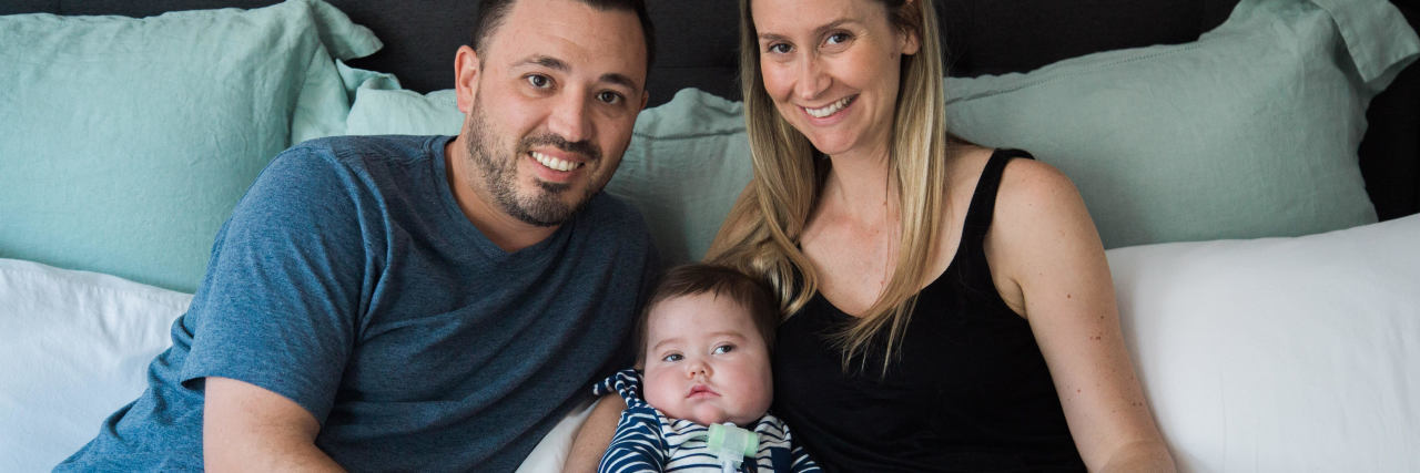 Parenting a Child With a CNTNAP1 Genetic Mutation The author and her partner holding their baby