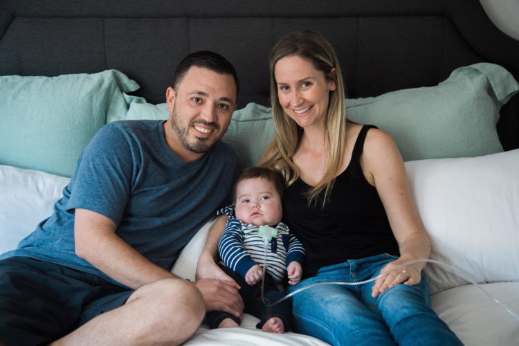 The author and her partner holding their baby