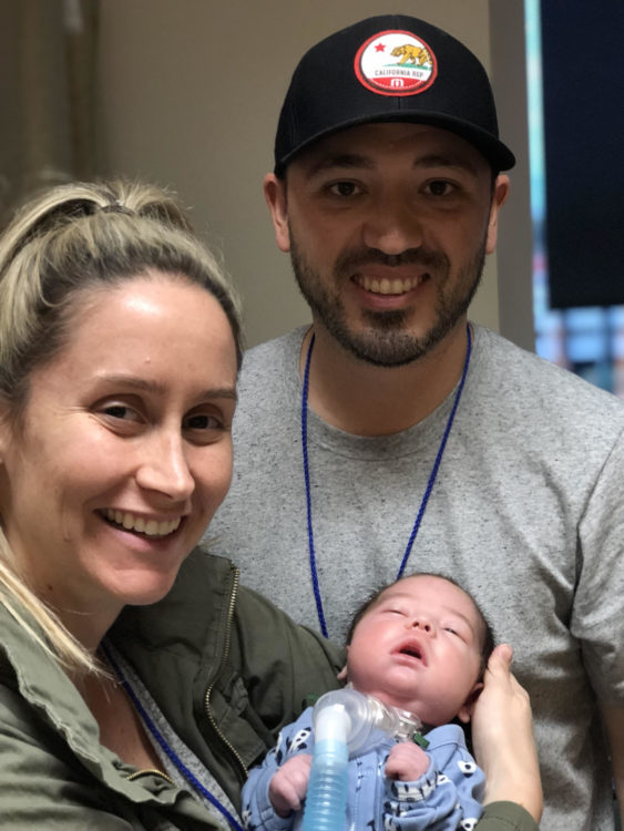 The author and her partner holding their baby