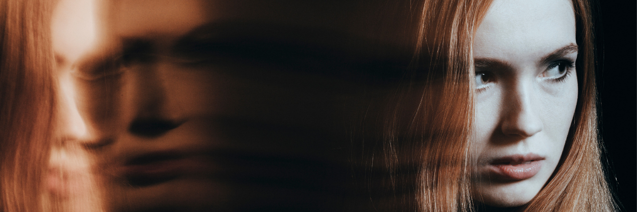 Paranoid thoughts People With Bipolar Disorder Have Woman with red hair looking suspiciously over her should. There's a blurred image of her face next to her.