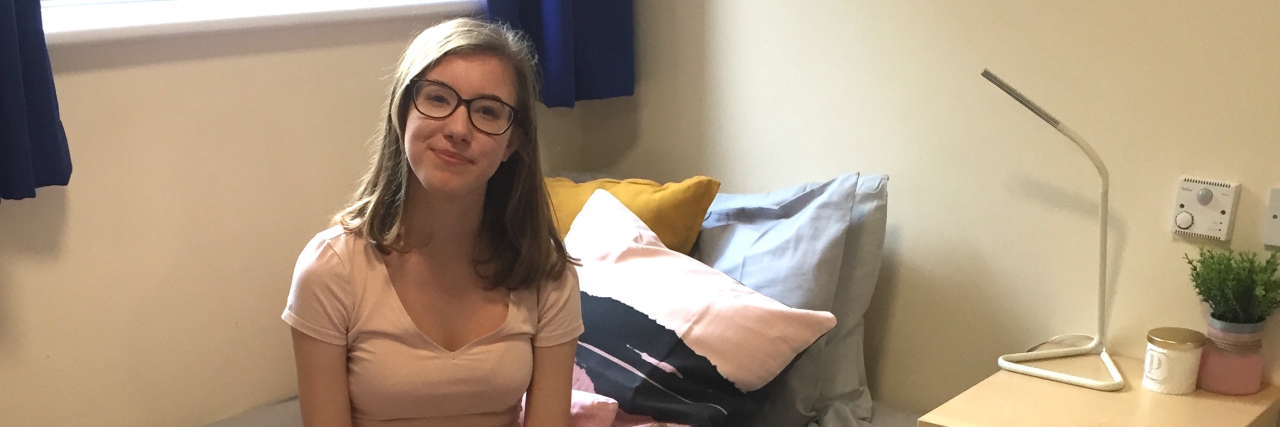 How Having an Autistic Brother Has Shaped My 'Typical' Daughter Phoebe sitting on her bed looking at the camera