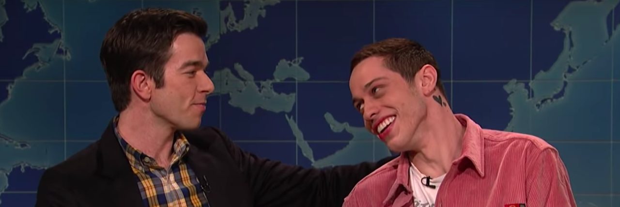 john mulaney and pete davidson looking at one another on SNL's Weekend Update