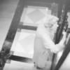 woman knocking on door in security camera footage