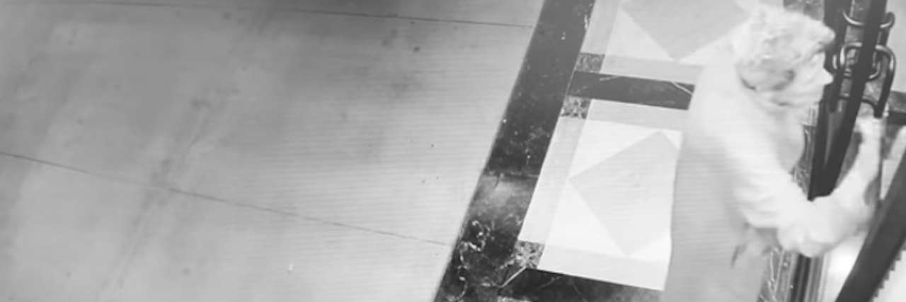 Hospital Leaves Woman With Alzheimer's Alone Outside Care Facility woman knocking on door in security camera footage