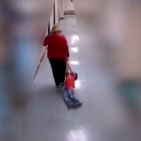 Screenshot of teacher dragging boy down school hallways