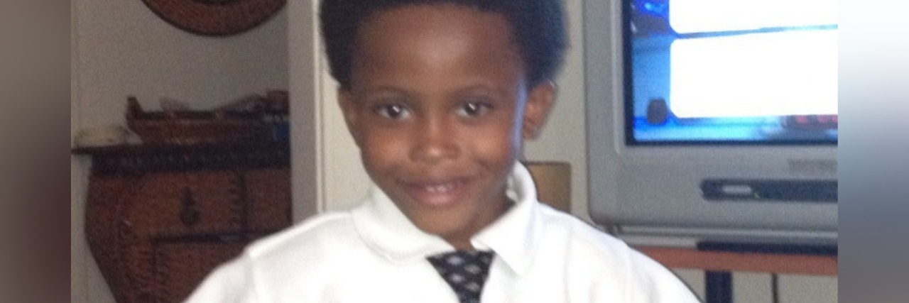 10-Year-Old Dies by Suicide After Being Bullied for Bowel Condition Seven Bridges wearing white collared shirt and tie