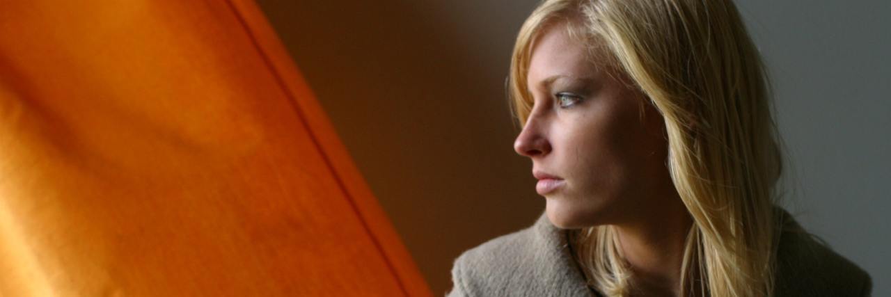 To People Who Don't Believe I Was Sexually Assaulted photo of blonde woman looking serious and off to side against gold orange background