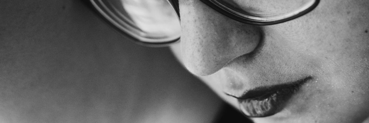 What It's Like to Have Both Sexual Trauma and Bipolar Hypersexuality close up black and white portrait photo of woman wearing glasses