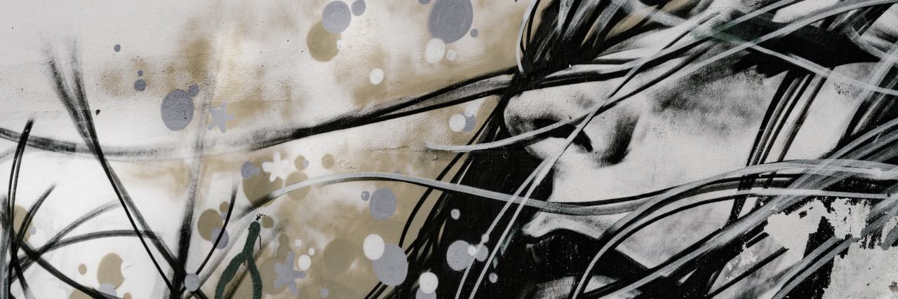 Misconceptions About Self-Harm painting or photograph of street art of woman with long flowing hair and sad look on face