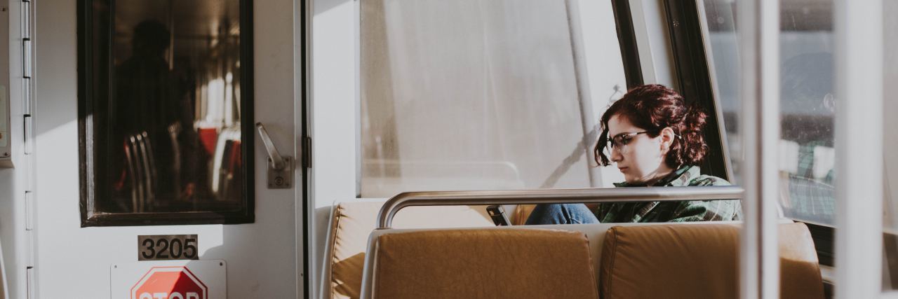 What Social Anxiety Isn't Like photo of young woman on train alone