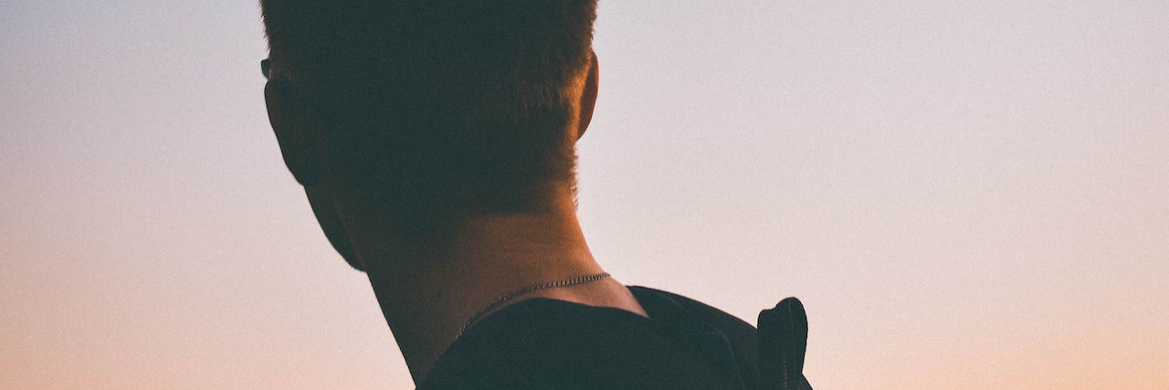 How to Stop Blaming Yourself for Someone's Suicide A man looking out into the sun set