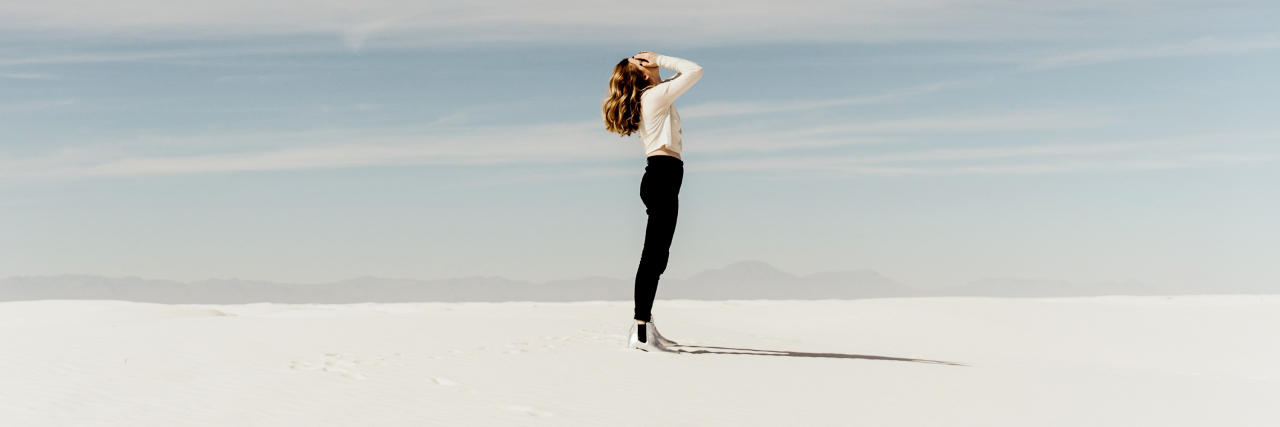 Borderline Personality Disorder Stereotypes That Hurt People blonde woman on empty beach with hands covering face and cloudy sky