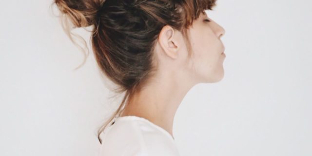 photo of woman in profile on white background with eyes closed