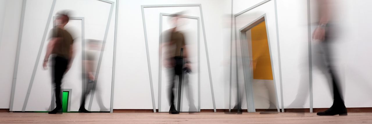 multiple exposure photograph of man standing in different positions in art exhibit