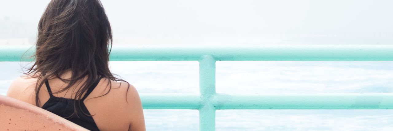 Breaking Up With Someone Who Has Depression photo of woman sitting alone by sea looking over railing