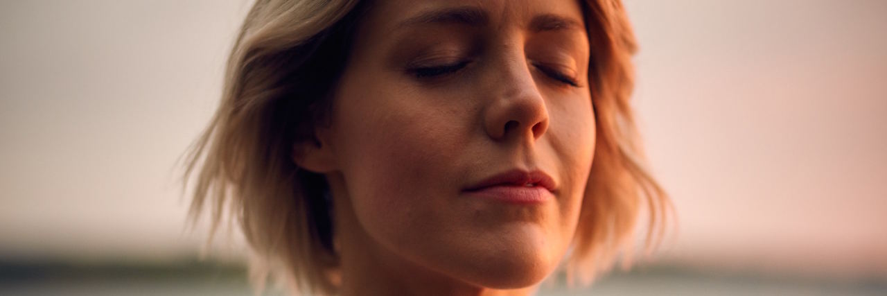 woman breathing with hand over heart