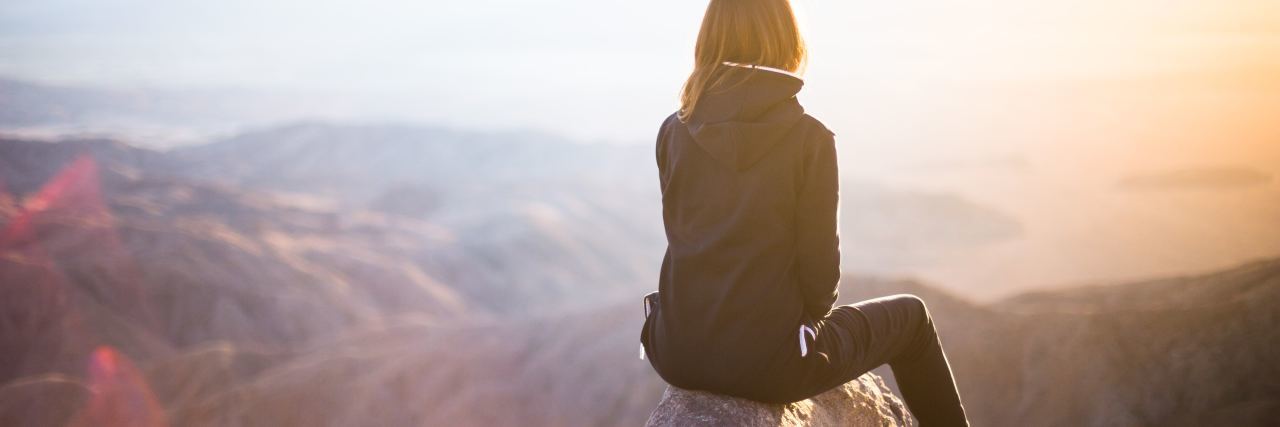 Quotes to Help With Depression and Anxiety woman sitting on mountaintop watching sunset