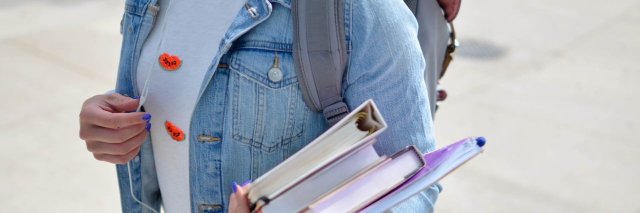 Not Allowed to Participate in School Event Due to Anxiety student holding books