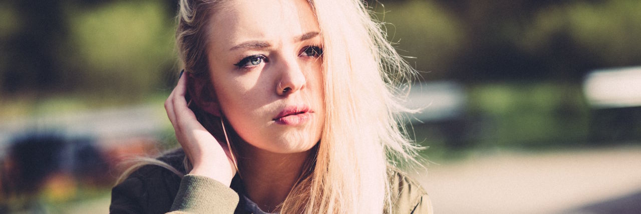 To the Person Who Dismissed My Need for Antidepressants woman tucking hair behind ear