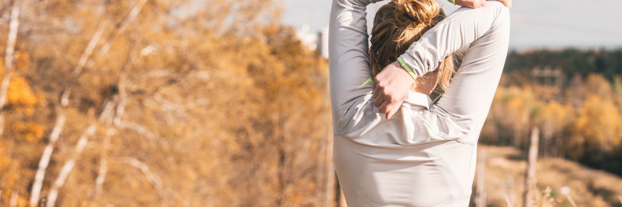 ‘Neuroplasticity’ Means We Can Heal From Mental Illness photo of woman stretching outdoors