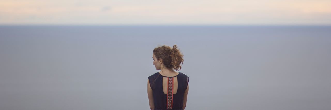Is Calling Someone a 'Psycho' Wrong? photo of woman standing at ocean alone looking out at horizon