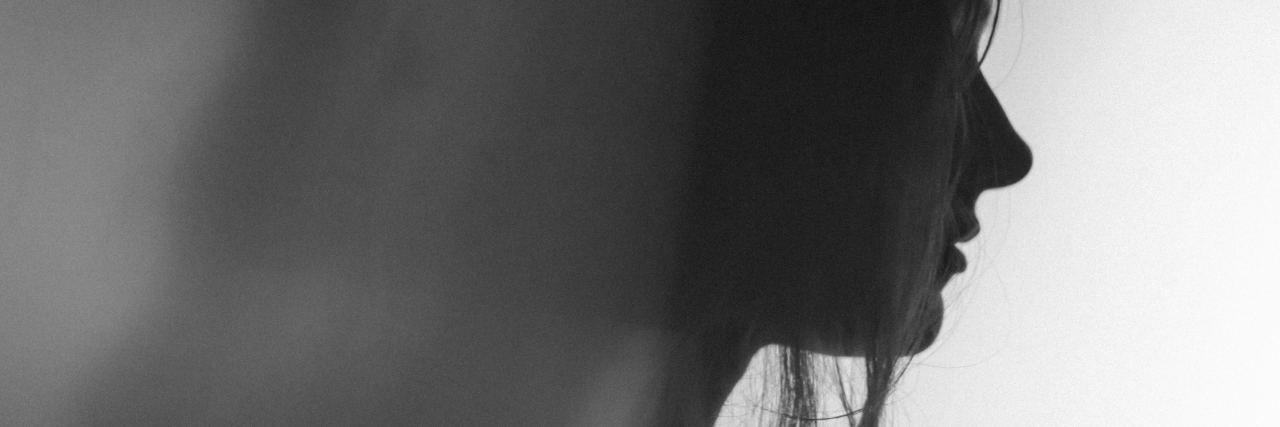 Can You Have Mental Illness With Chronic Illness? photo of woman in profile silhouetted against white background