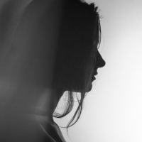 photo of woman in profile silhouetted against white background