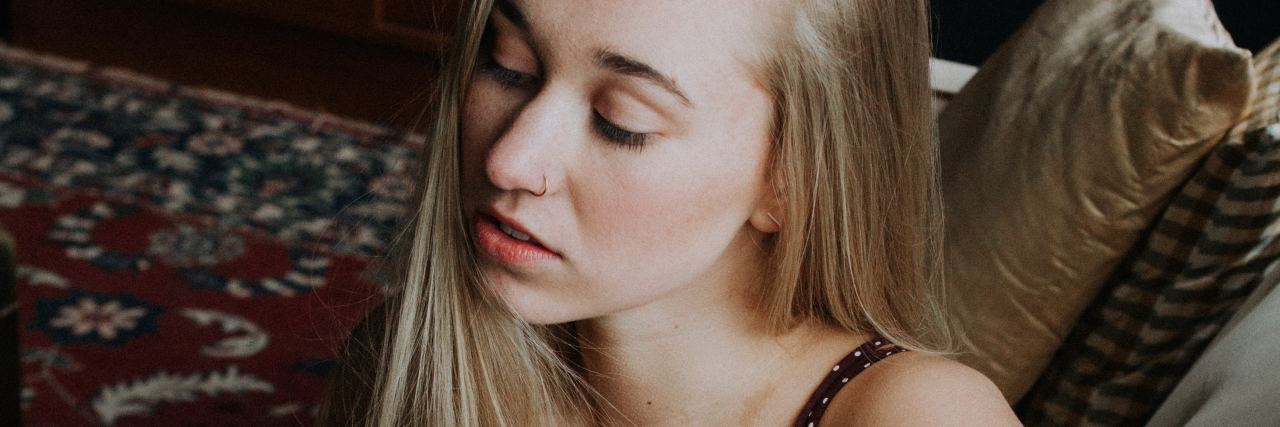 Allow Yourself to Feel 'Extreme' Borderline Emotions photo of young blonde woman sitting on couch with eyes closed