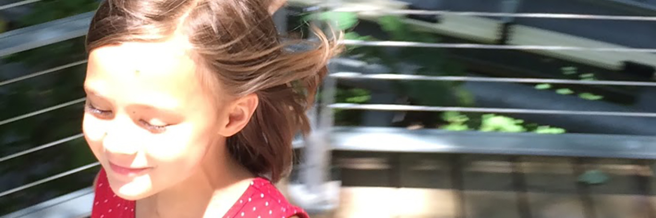 Lessons From Difficult Days Raising a Daughter on the Autism Spectrum Juniper, little girl playing outside.