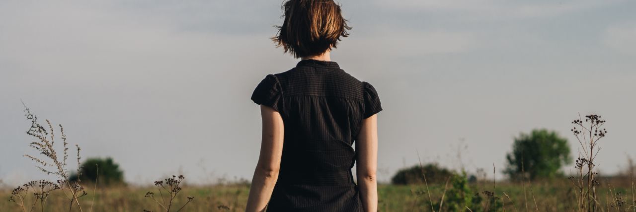 Find It Hard to Explain What to Know About Borderline photo of woman standing in field facing away from camera