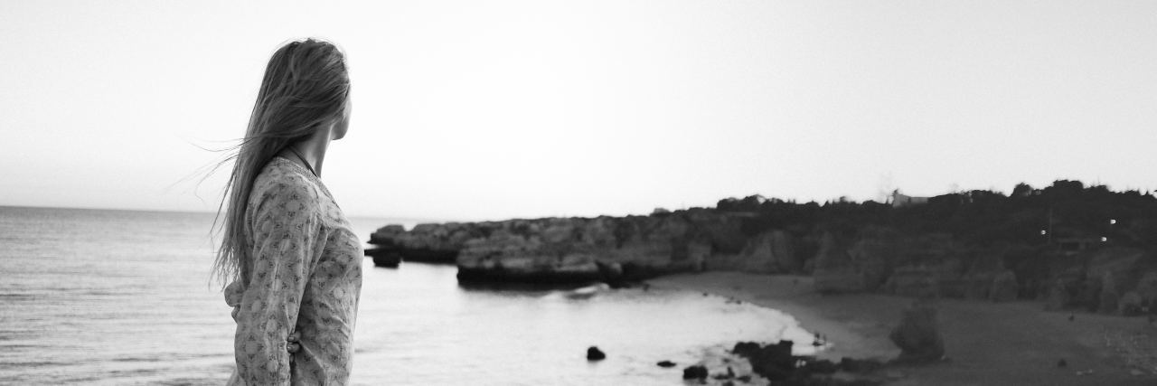 How Memory Protected Me from the Trauma of Sexual Abuse black and white photo of woman on beach looking into distance as if lost in memory or thought