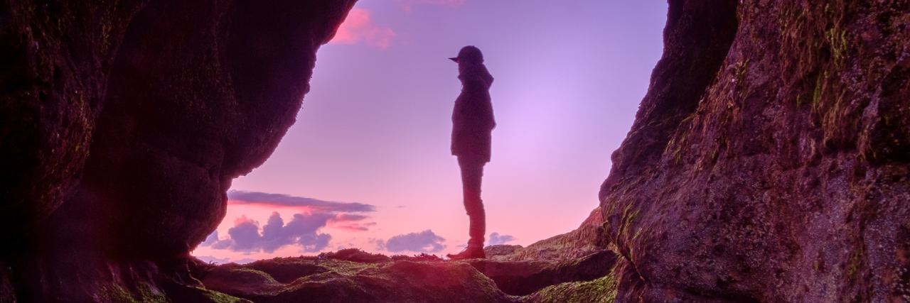 When You Feel Depression Coming Back but Feel Stronger This Time photo of man reflected in pool of water framed and silhouetted by sunset and rock