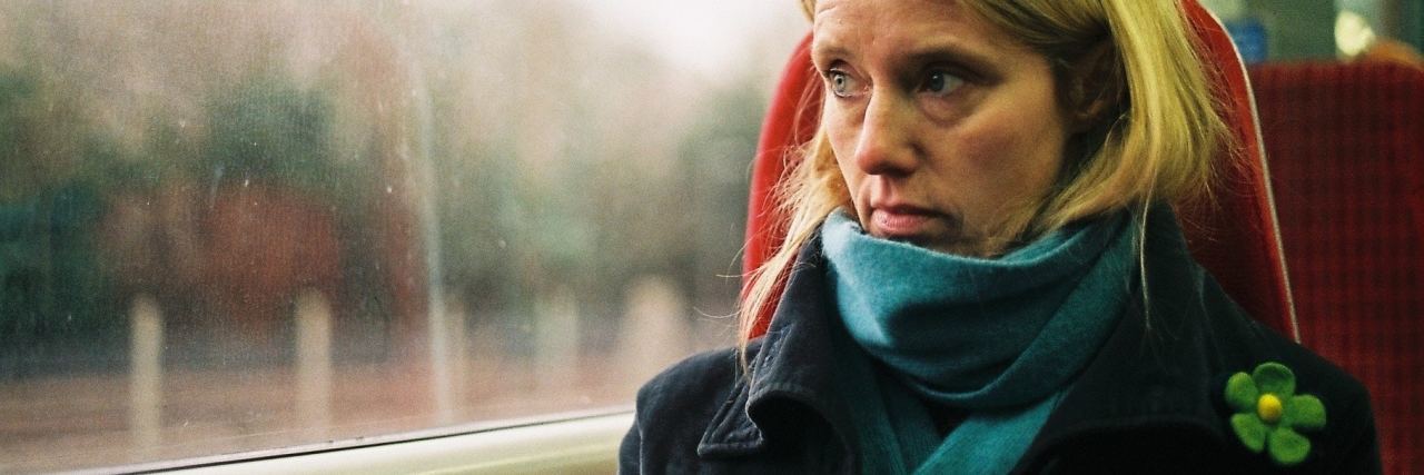 Is It OK to Cut Toxic People From Your Life for Your Mental Health? photo of woman looking serious looking out of window on train