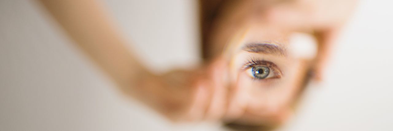 The Truth About ADHD Medication and Misinformation woman looking into mirror while everything else is out of focus