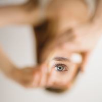 woman looking into mirror while everything else is out of focus
