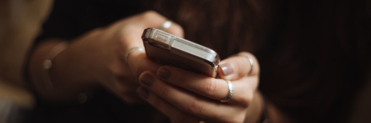 Why People Seek Attention When They Post About Their Chronic Illness woman texting on her phone