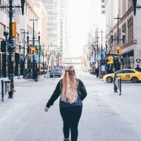 photo of woman standing in busy street