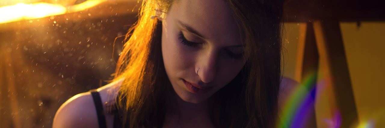 Surprising Physical Reactions in EMDR Therapy photo of young woman in golden sunlight with rainbow light flare
