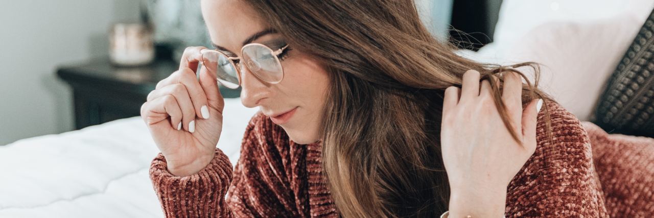 Exercise to Try If You Struggle With Complex Emotions From Dreams photo of woman lying on bed with glasses and notepads