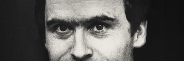 Black and white photo of a middle-aged Ted Bundy smiling.