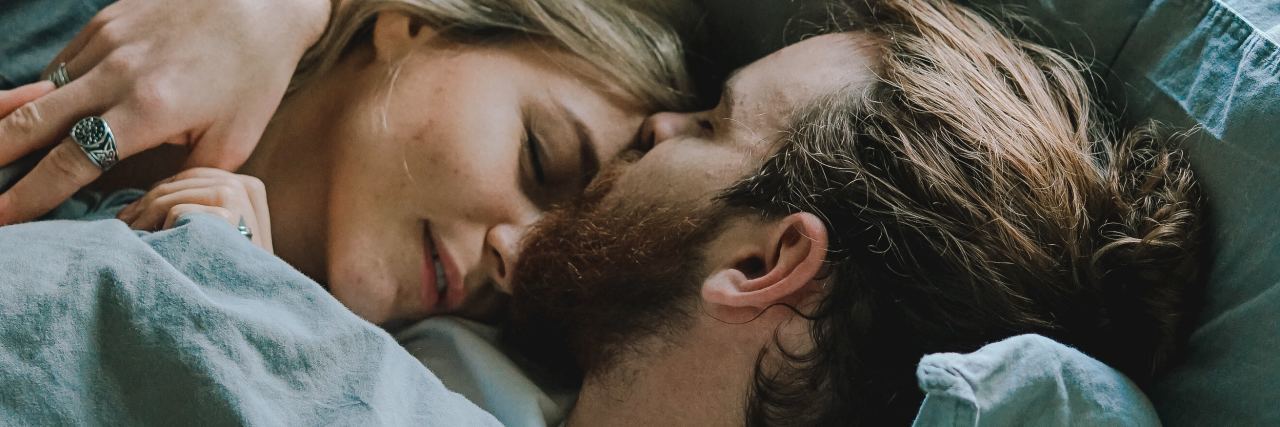 The Perfect Way My Partner Reacted to a BPD Meltdown close up photo of couple lying in bed holding each other