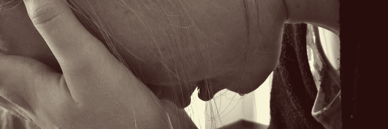 When I Doubt Myself as a Parent of a Child With a Disability Woman resting head in hands, sad.