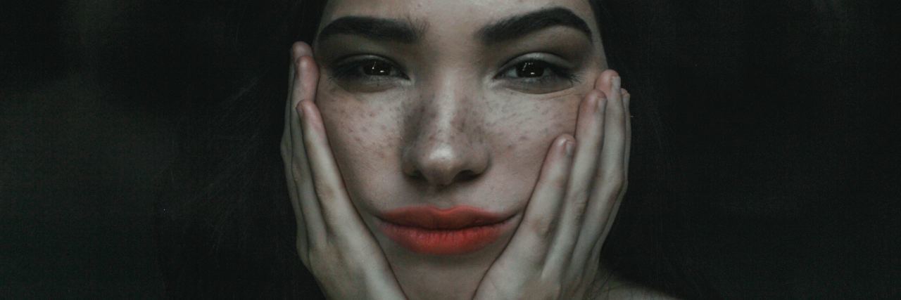 8 'Problematic' Thoughts I Have During an Anxiety Episode woman with hands on face, expression overwhelmed