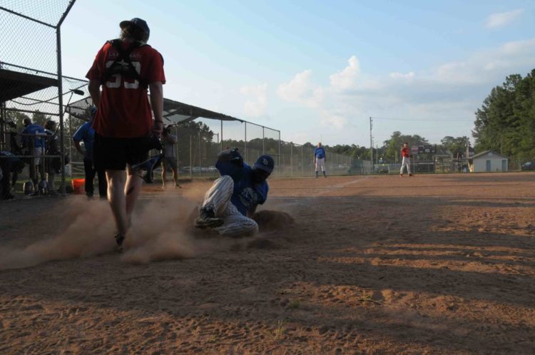 man sliding to base