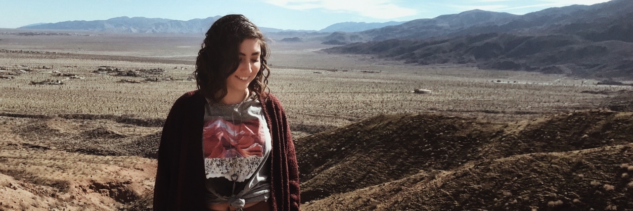 Post Ideas Instead of 'Before and After' Eating Disorder Photos photo of woman posing in front of desert location with mountains and blue sky with clouds